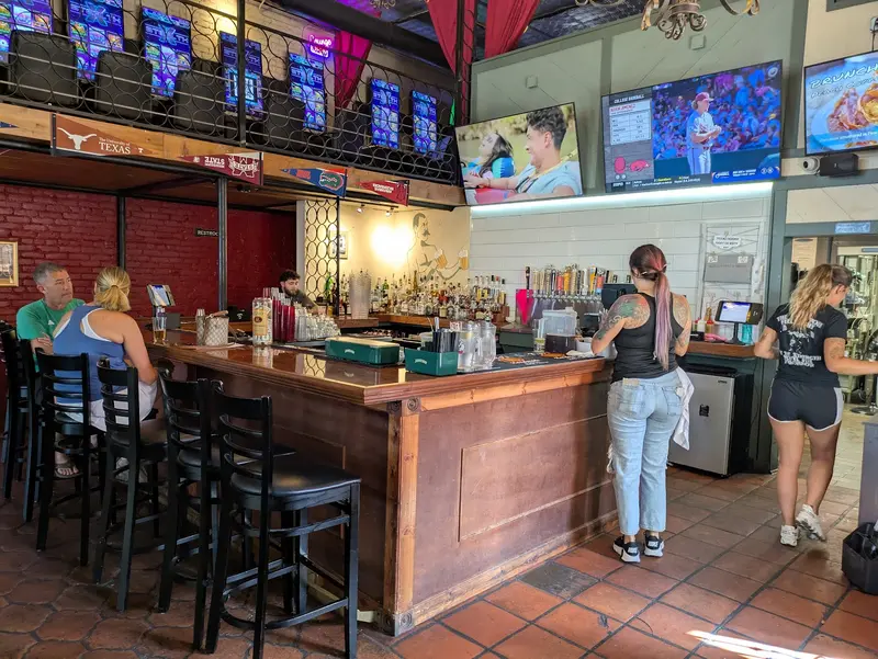 The corner bar at The Victory Tap, taps along the back wall and screens above