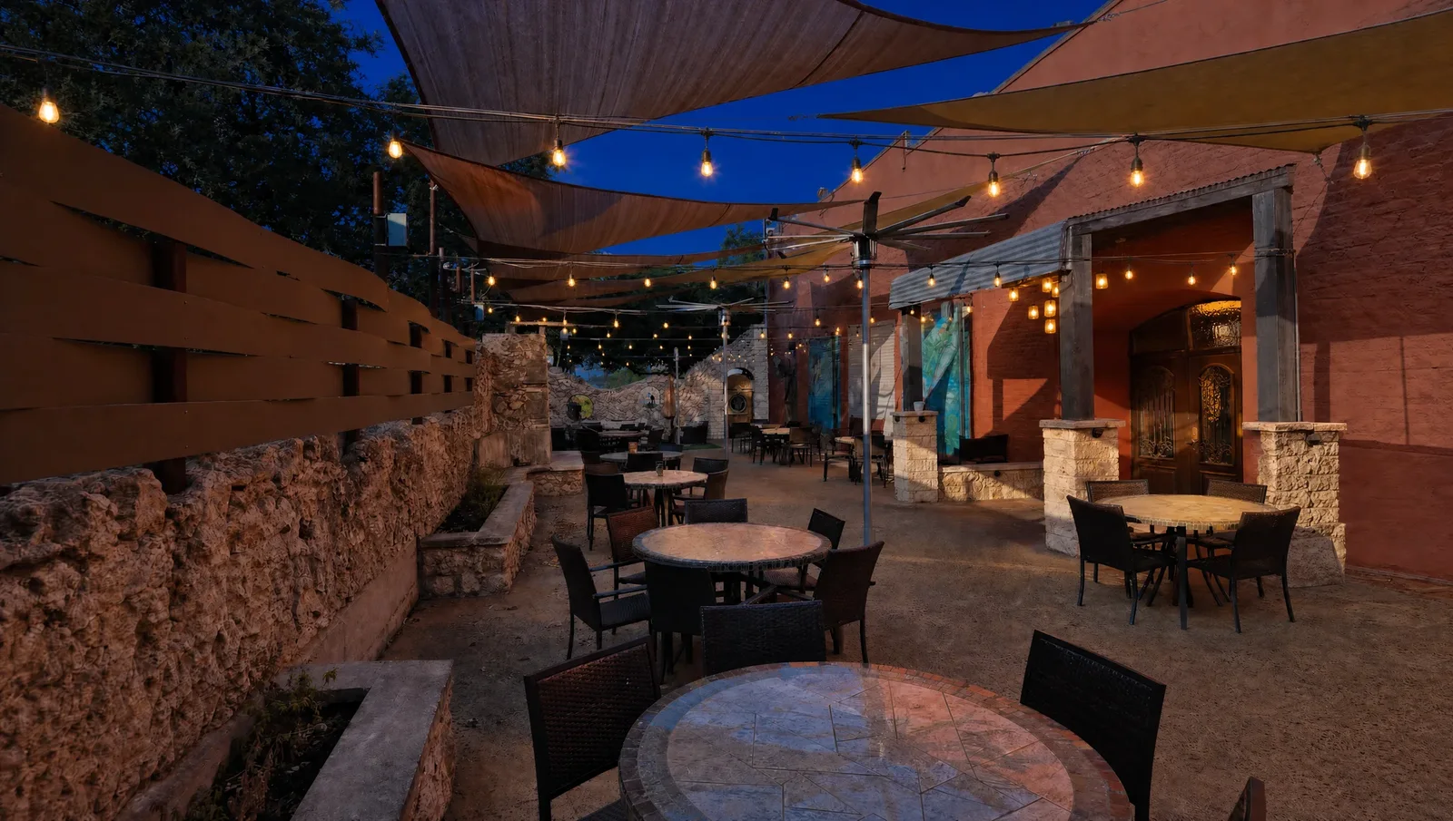 The patio at night, string lights glowing under a dark blue sky